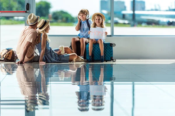 Parents and kids waiting for boarding in airport — Stock Photo