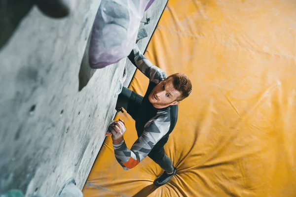 Man climbing wall with grips — Stock Photo