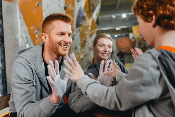 Dad and son showing palms in talcum — Stock Photo