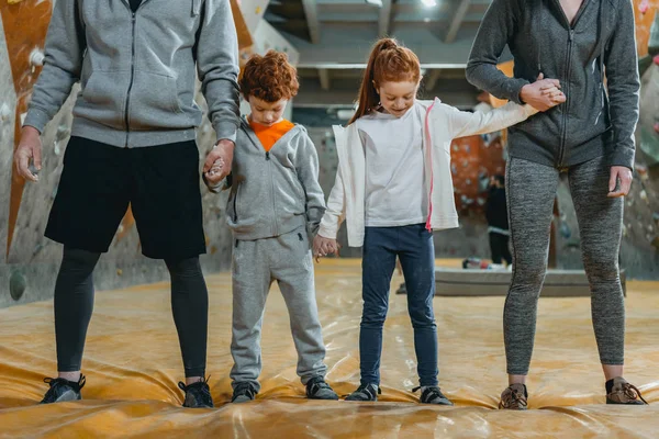 Family holding hands at gym — Stock Photo
