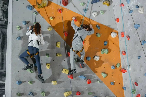 Two little kids climbing wall with grips — Stock Photo