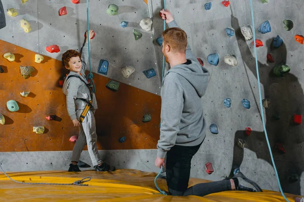 Niño pequeño en arnés de escalada - foto de stock