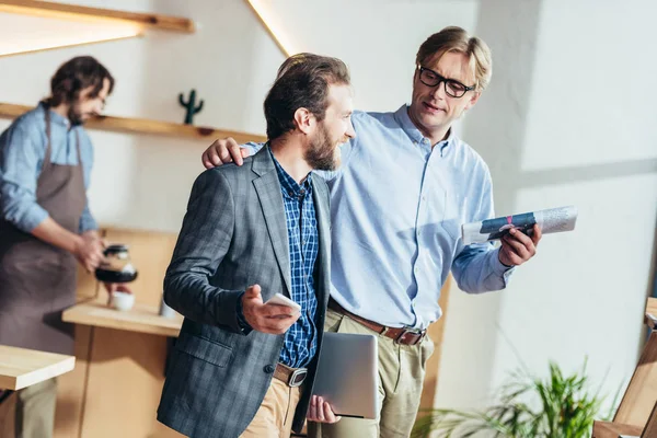 Businessmen talking in cafe — Stock Photo