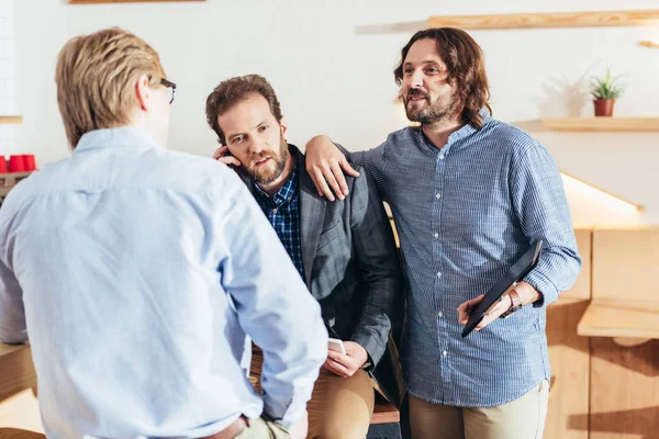 Businessmen working and talking in cafe — Stock Photo