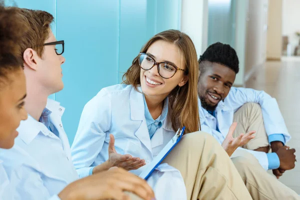 Doctors sitting on floor in hospital — Stock Photo