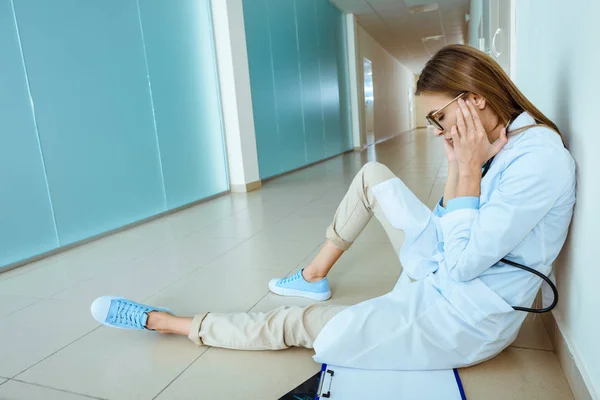 Doctor sitting in hospital corridor — Stock Photo