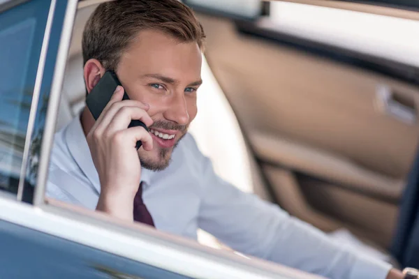 Man with smartphone in car — Stock Photo