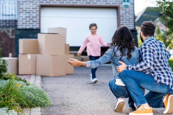 Girl running to hug parents — Stock Photo