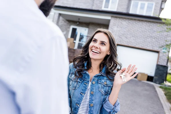Surprised woman with keys in hand — Stock Photo