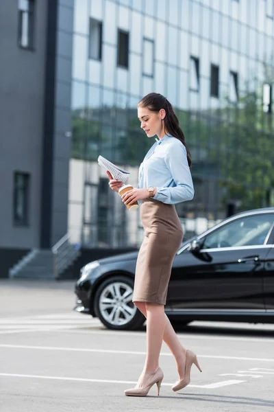 Businesswoman reading business newspaper — Stock Photo