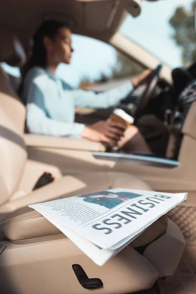Business newspaper in car — Stock Photo