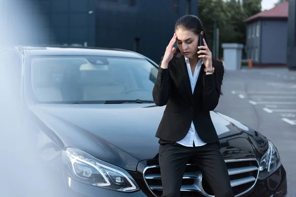 Troubled businesswoman talking on phone — Stock Photo