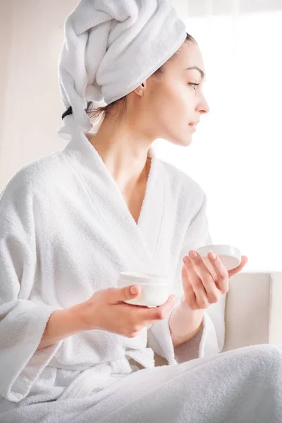 Mujer sosteniendo tarro de crema - foto de stock