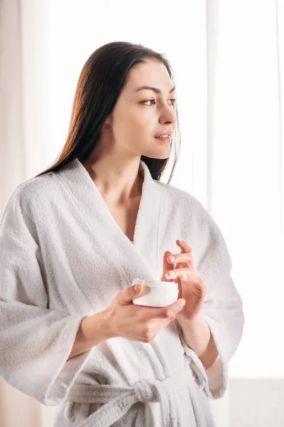 Woman applying face cream — Stock Photo