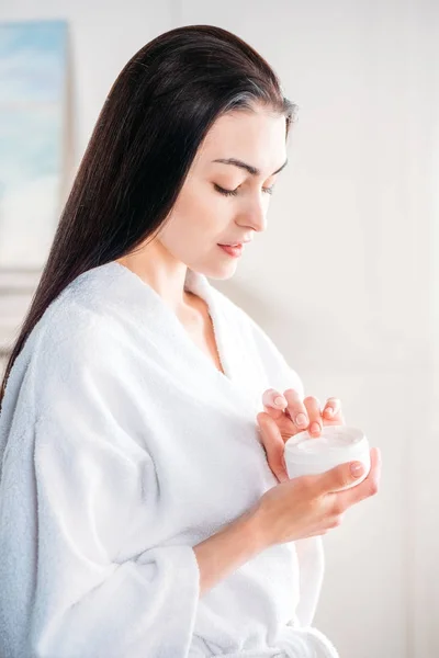 Mulher aplicando creme facial — Fotografia de Stock