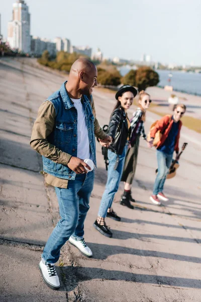 Multicultural friends holding hands — Stock Photo