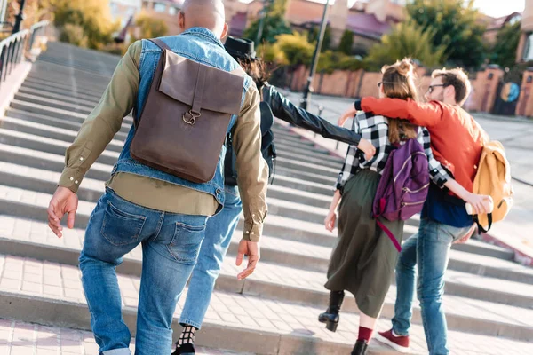 Multicultural friends walking on street — Stock Photo