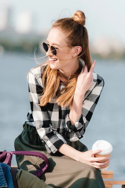 Cheerful woman with coffee to go — Stock Photo