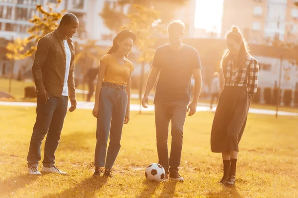 Multicultural friends playing soccer — Stock Photo