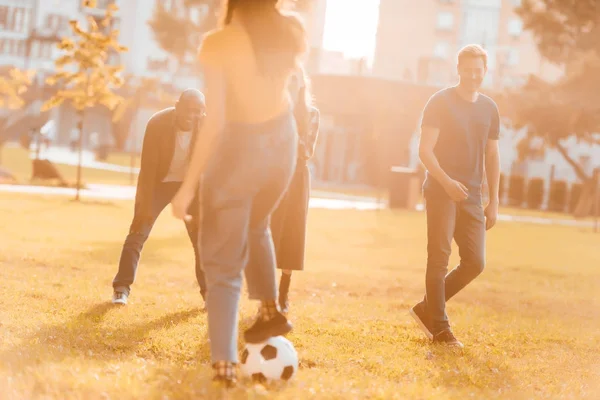 Amigos multiculturales jugando al fútbol - foto de stock