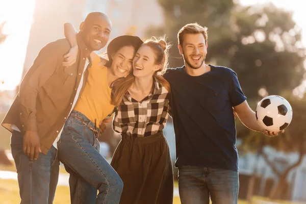 Multicultural friends with soccer ball — Stock Photo