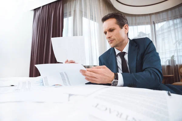 Businessman reading paperwork — Stock Photo