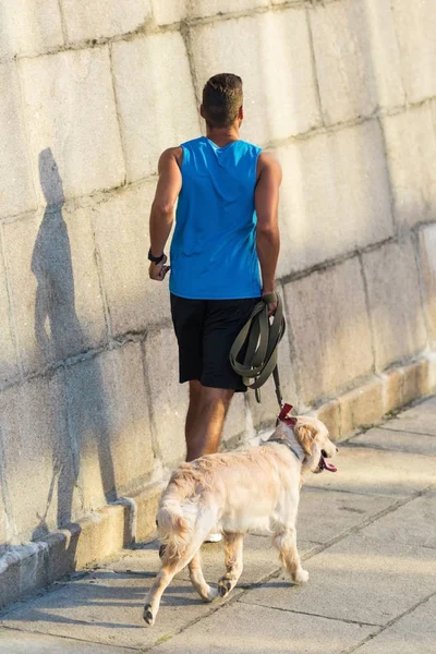 Sportsman running with dog — Stock Photo