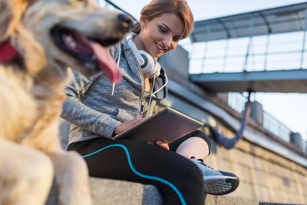 Sportswoman using digital tablet — Stock Photo