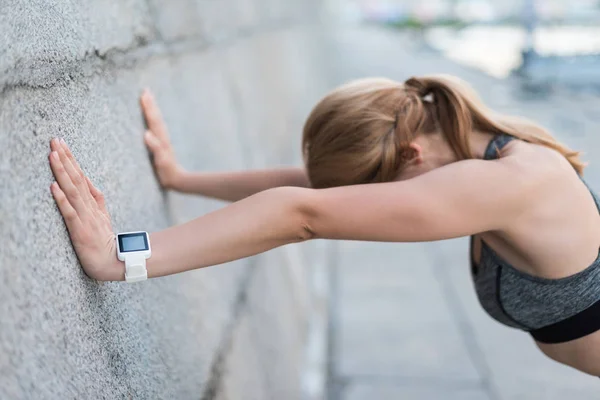 Exhausted sportswoman with smart watch — Stock Photo