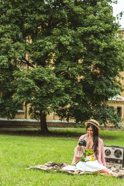 Stylish girl with camera in park — Stock Photo