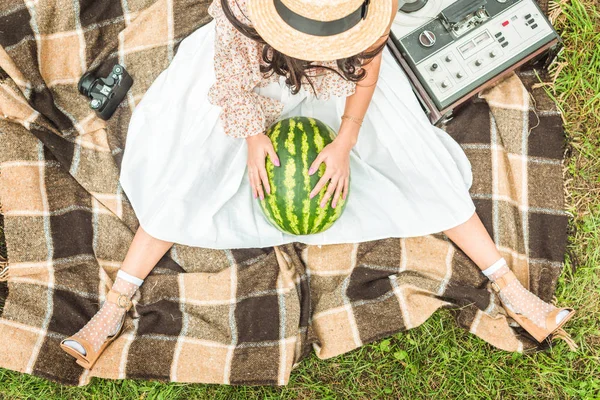 Girl with watermelon on plaid — Stock Photo