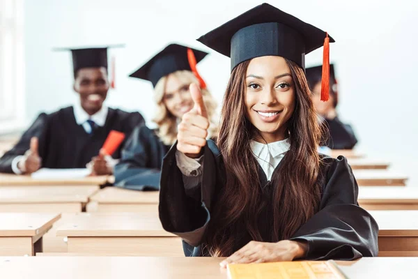 Student girl showing thumb up — Stock Photo