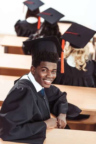 African american student in graduation costume — Stock Photo