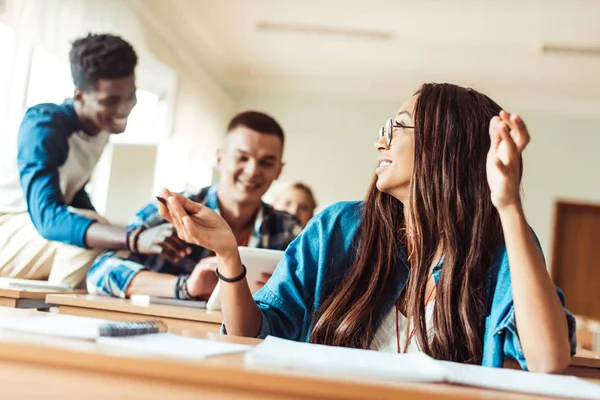 Student girl talking to classmates — Stock Photo