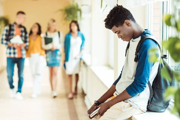 Tired student sitting on windowsill — Stock Photo