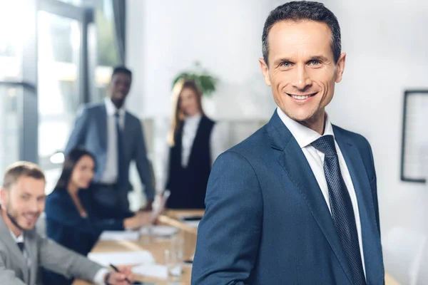 Hombre de negocios guapo mirando la cámara - foto de stock