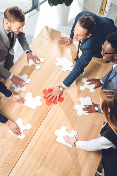 Assembling puzzle — Stock Photo