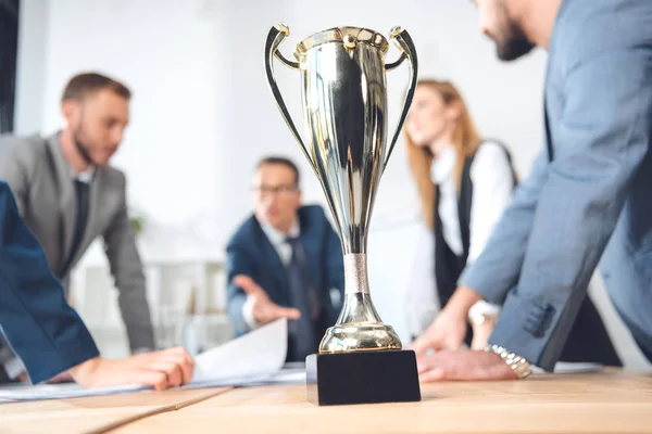 Champion cup standing in office — Stock Photo