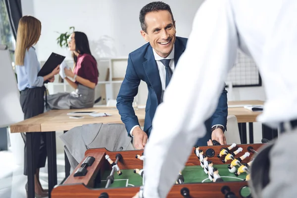 Businessmen playing table football — Stock Photo