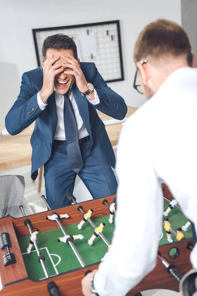 Businessmen playing table football — Stock Photo