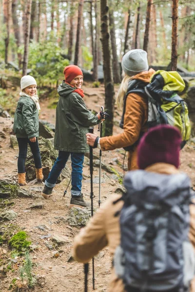 Parents and kids trekking in forest — Stock Photo