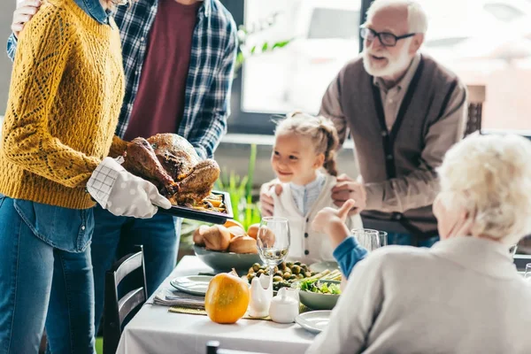 Family looking at thanksgiving turkey — Stock Photo