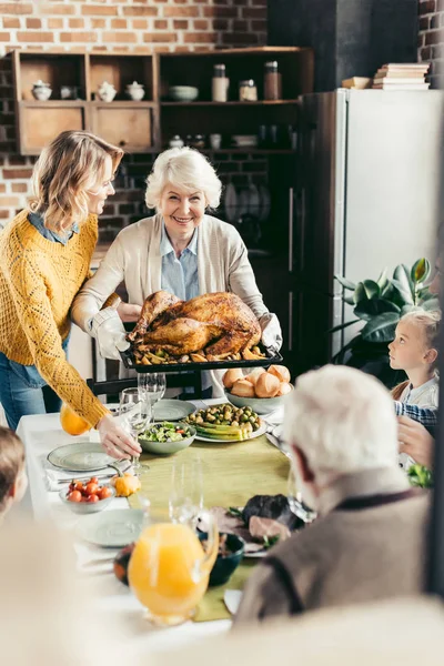 Senior woman and her daughter with turkey — Stock Photo