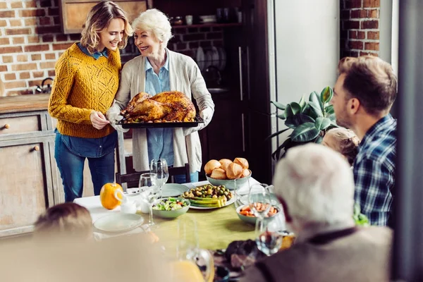 Senior woman and her daughter with turkey — Stock Photo