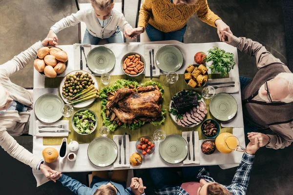 Family praying before holiday dinner — Stock Photo