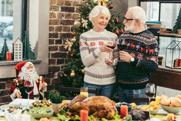 Senior couple clinking glasses on christmas — Stock Photo