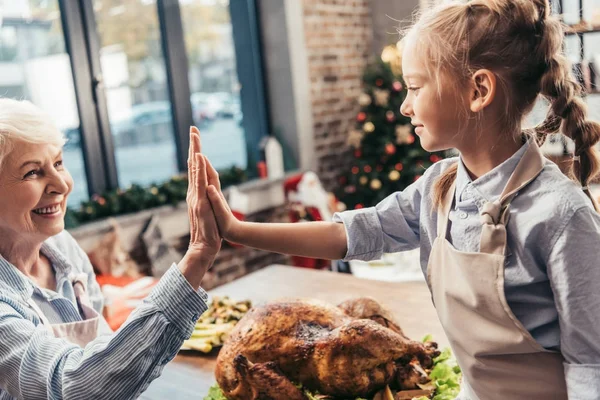 Grandmother and granddaughter giving high five — Stock Photo