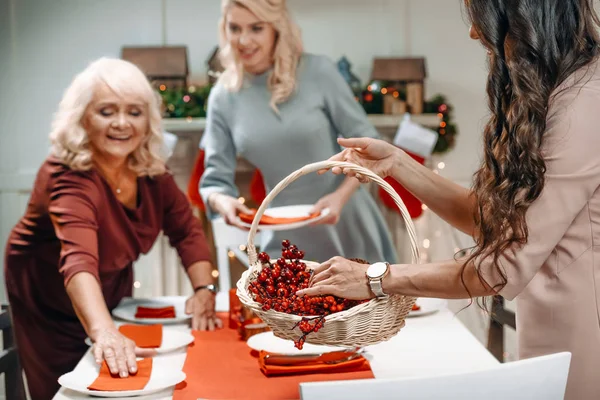 Women decorating christmas table — Stock Photo