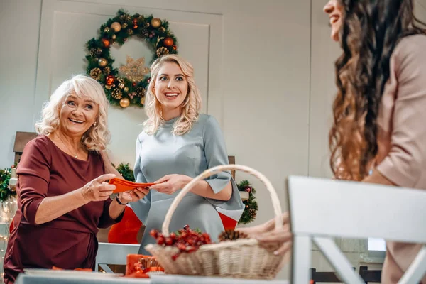 Women decorating christmas table — Stock Photo