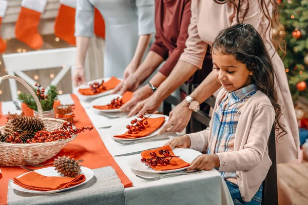 Girl decorating christmas table — Stock Photo